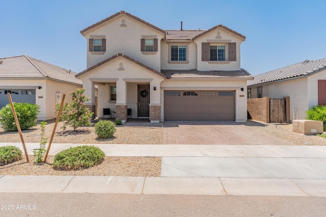 14435 W El Cortez Pl, Surprise, AZ 85387 - view of front facade featuring driveway, covered porch, an attached garage, stucco siding, and a tile roof