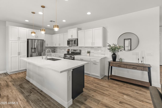 14435 W El Cortez Pl, Surprise, AZ 85387 - kitchen with stainless steel appliances, a sink, white cabinetry, decorative backsplash, and light countertops