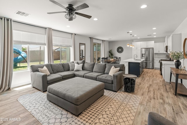 14435 W El Cortez Pl, Surprise, AZ 85387 - living room with ceiling fan, plenty of natural light, light wood finished floors, and recessed lighting