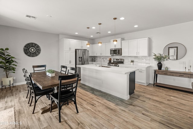 14435 W El Cortez Pl, Surprise, AZ 85387 - dining area featuring recessed lighting, light wood-style floors, and baseboards
