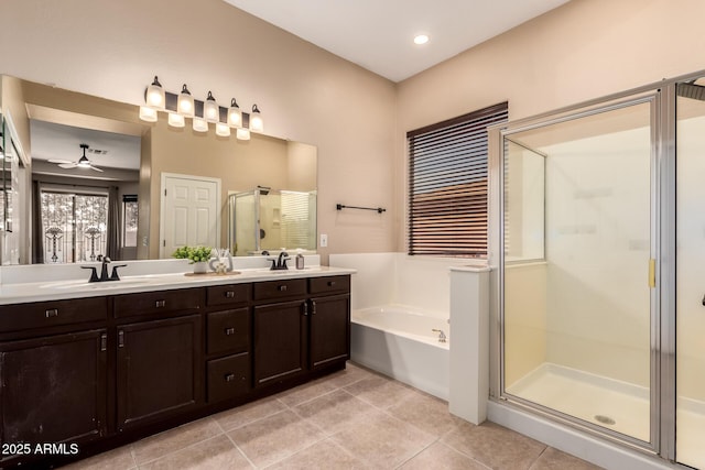 full bath with a ceiling fan, a bath, a shower stall, tile patterned flooring, and double vanity