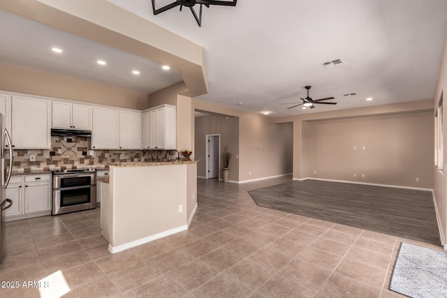 kitchen with recessed lighting, range with two ovens, light tile patterned floors, ceiling fan, and tasteful backsplash