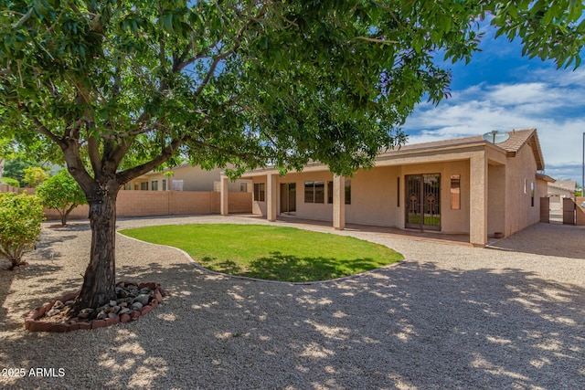 back of property with fence private yard, a patio area, and stucco siding
