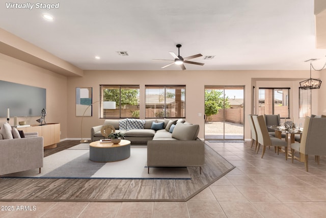 living room featuring light tile patterned floors, visible vents, baseboards, and recessed lighting
