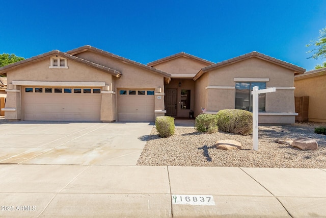 16837 W Northampton Rd, Surprise, AZ 85374 - view of front of property with an attached garage, concrete driveway, stucco siding, and a tiled roof