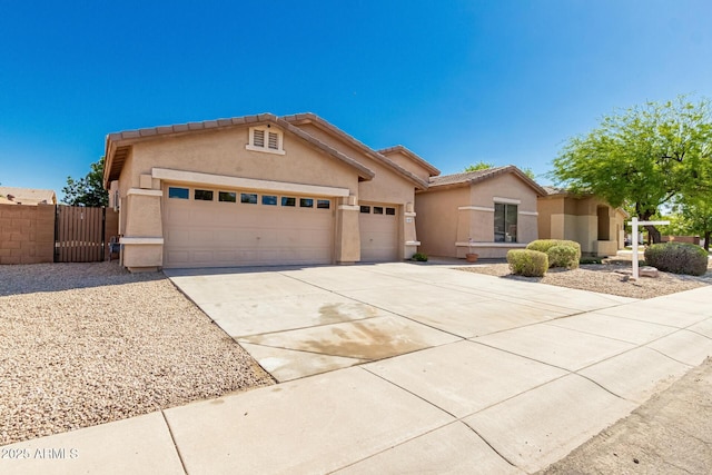 16837 W Northampton Rd, Surprise, AZ 85374 - view of front of home with a garage, concrete driveway, stucco siding, a tiled roof, and a gate