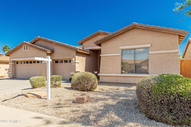 16837 W Northampton Rd, Surprise, AZ 85374 - view of front facade featuring an attached garage, concrete driveway, stucco siding, and a tile roof