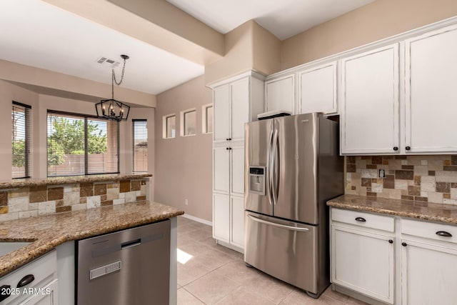 kitchen with decorative backsplash, white cabinets, light tile patterned floors, and appliances with stainless steel finishes