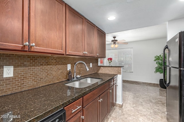 kitchen with sink, ceiling fan, dark stone countertops, backsplash, and black appliances