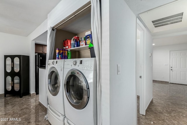 clothes washing area featuring independent washer and dryer