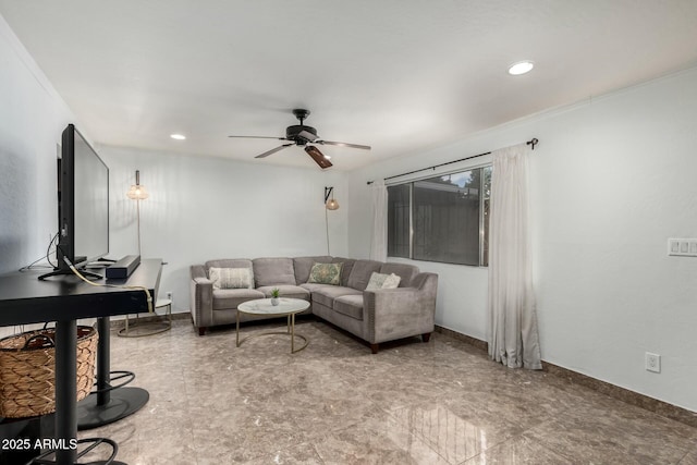 living room featuring ornamental molding and ceiling fan