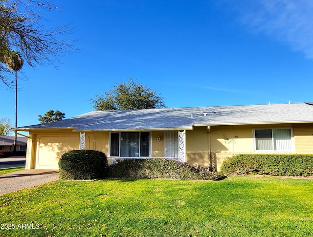 ranch-style house with a garage and a front yard