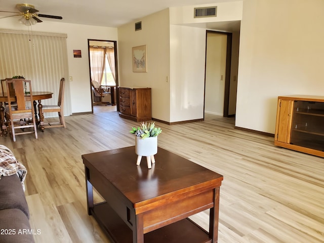 living room featuring ceiling fan and light wood-type flooring