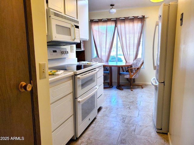 kitchen with white cabinetry and white appliances