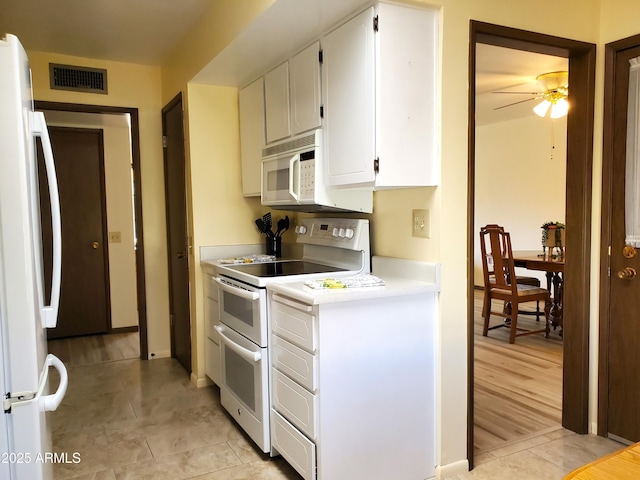 kitchen with white cabinetry, light tile patterned floors, ceiling fan, and white appliances