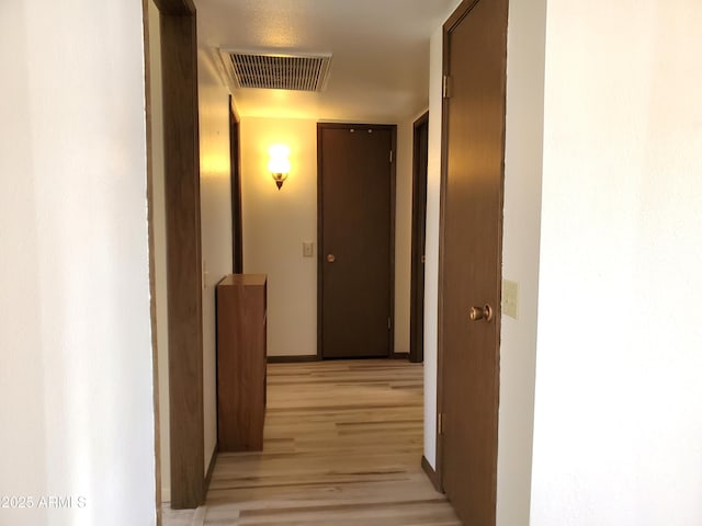 corridor with light hardwood / wood-style flooring