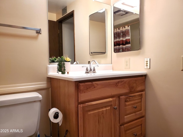 bathroom featuring vanity and toilet