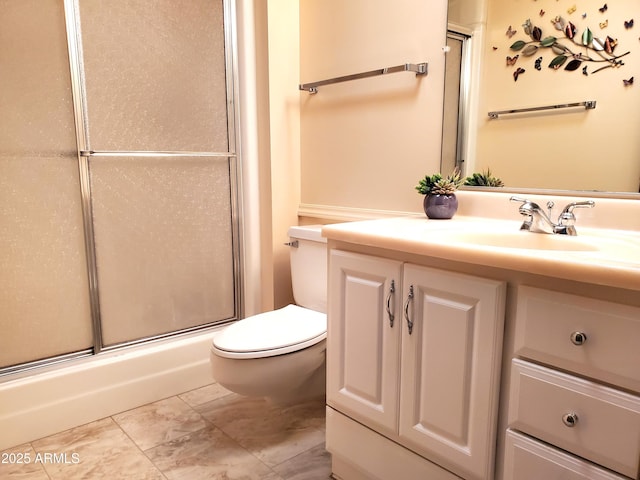 bathroom with vanity, walk in shower, and toilet