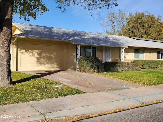 ranch-style house with a garage and a front lawn