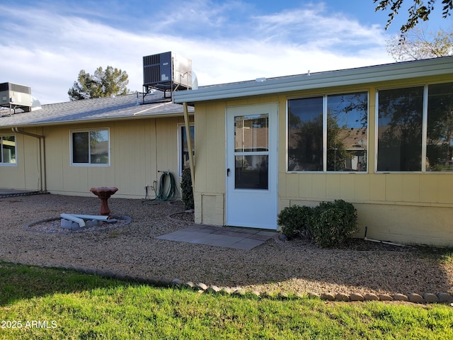 rear view of property featuring cooling unit