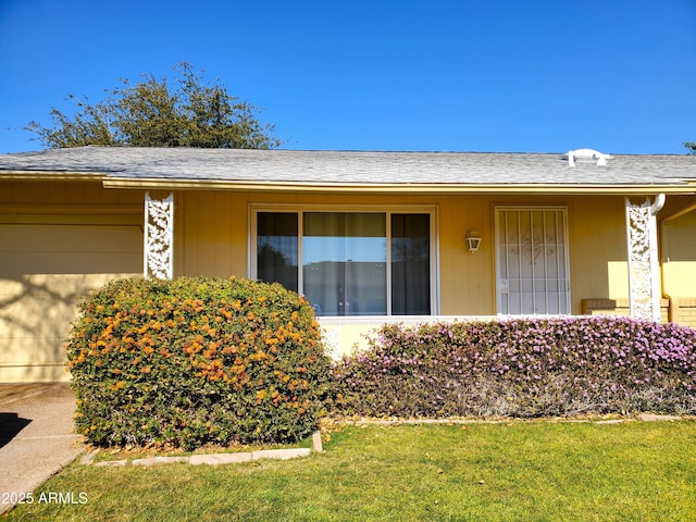 property entrance featuring a lawn