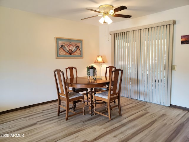 dining area with light hardwood / wood-style floors and ceiling fan