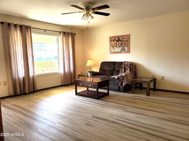 living room featuring light hardwood / wood-style floors and ceiling fan