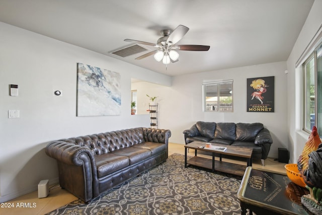 tiled living room featuring ceiling fan and a healthy amount of sunlight