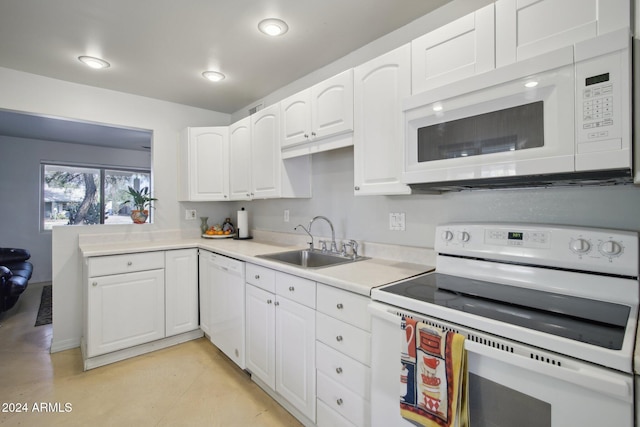 kitchen with white cabinetry, sink, and white appliances