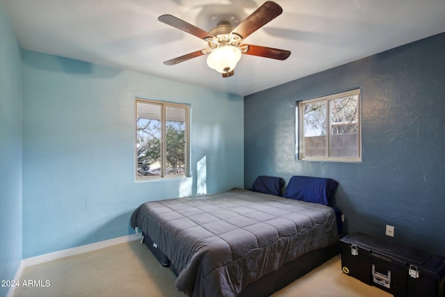 bedroom with ceiling fan and multiple windows