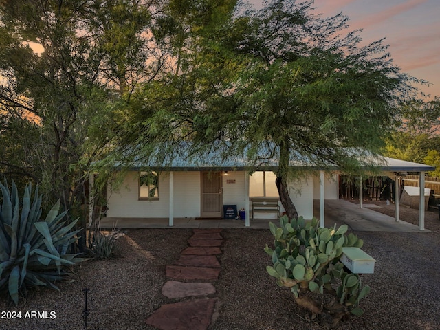 view of front of house featuring a carport and a porch