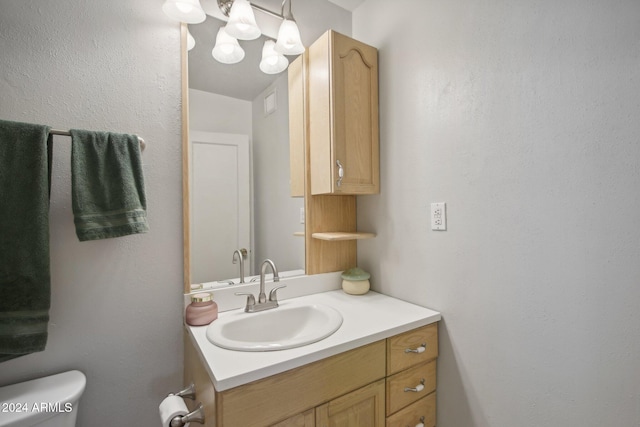 bathroom with toilet and vanity