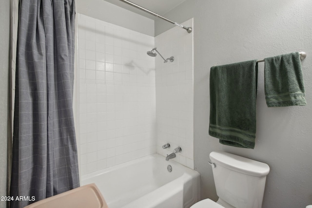 bathroom with shower / bath combo with shower curtain and toilet