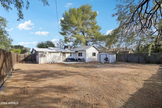 rear view of property with a shed