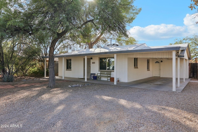 ranch-style house with a carport