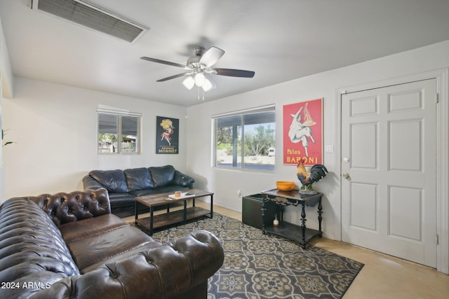 living room featuring concrete floors and ceiling fan