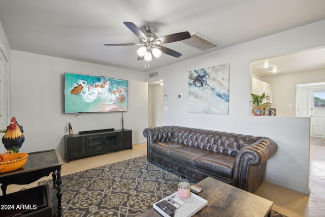 living room featuring light tile patterned floors and ceiling fan