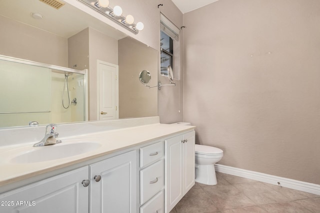 bathroom with vanity, toilet, tile patterned floors, and walk in shower