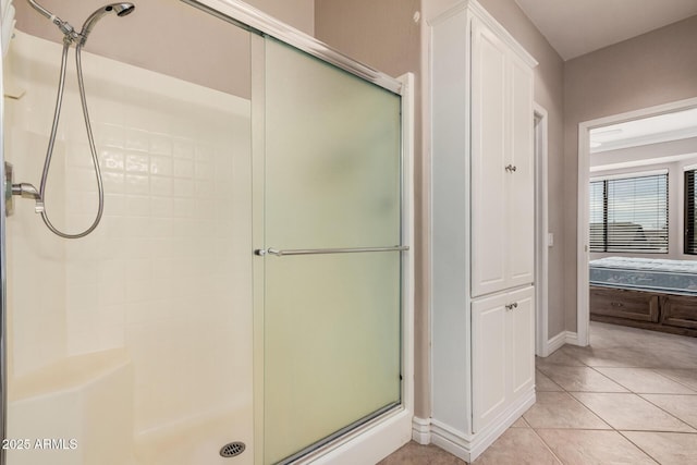 bathroom with tile patterned flooring and a shower with door