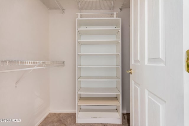 walk in closet featuring light tile patterned floors