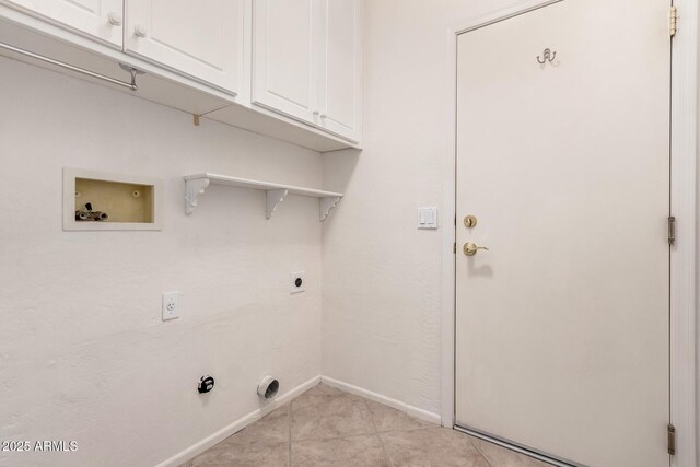 laundry room with gas dryer hookup, cabinets, light tile patterned floors, washer hookup, and hookup for an electric dryer