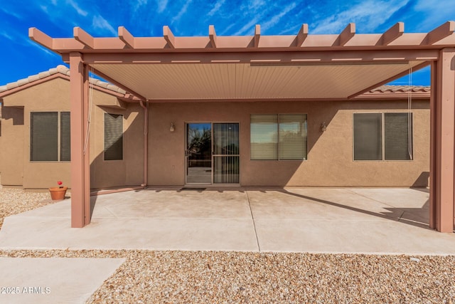 back of property with a patio