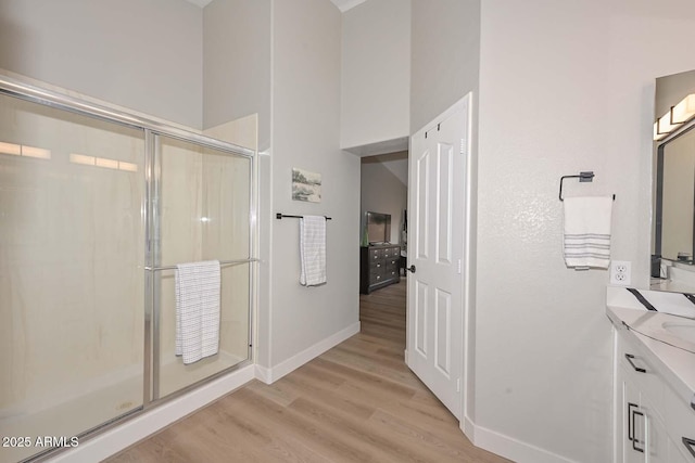 bathroom featuring vanity, wood-type flooring, and walk in shower