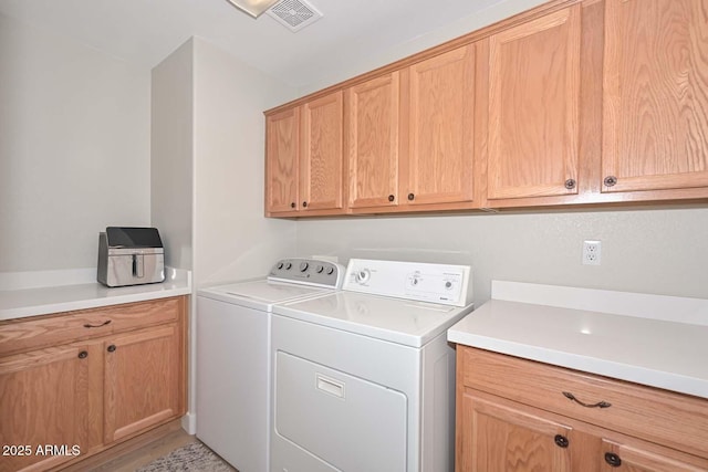 laundry room featuring cabinets and independent washer and dryer