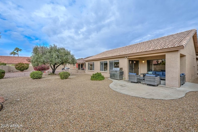 rear view of property with a patio and outdoor lounge area