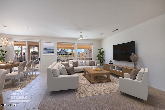 tiled living room with ceiling fan with notable chandelier