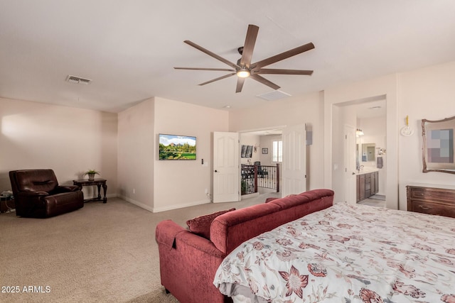 carpeted bedroom with ceiling fan and ensuite bathroom