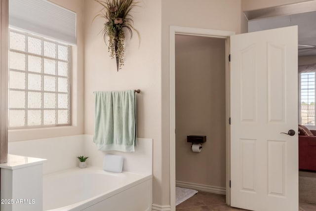 bathroom with tile patterned floors and a bathing tub