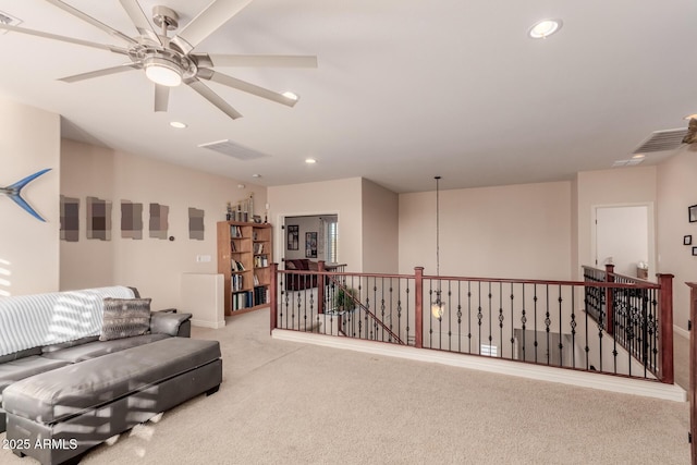 sitting room featuring light carpet and ceiling fan