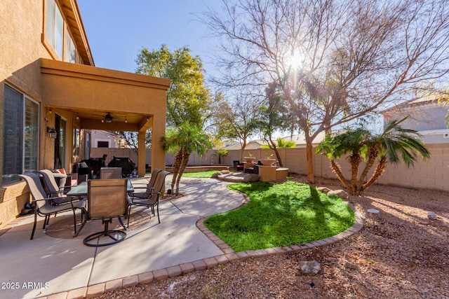 view of yard with a patio area and ceiling fan